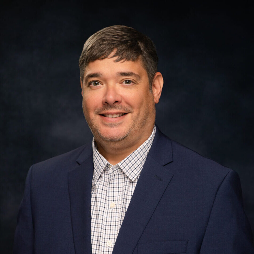 Portrait of smiling man in navy blazer